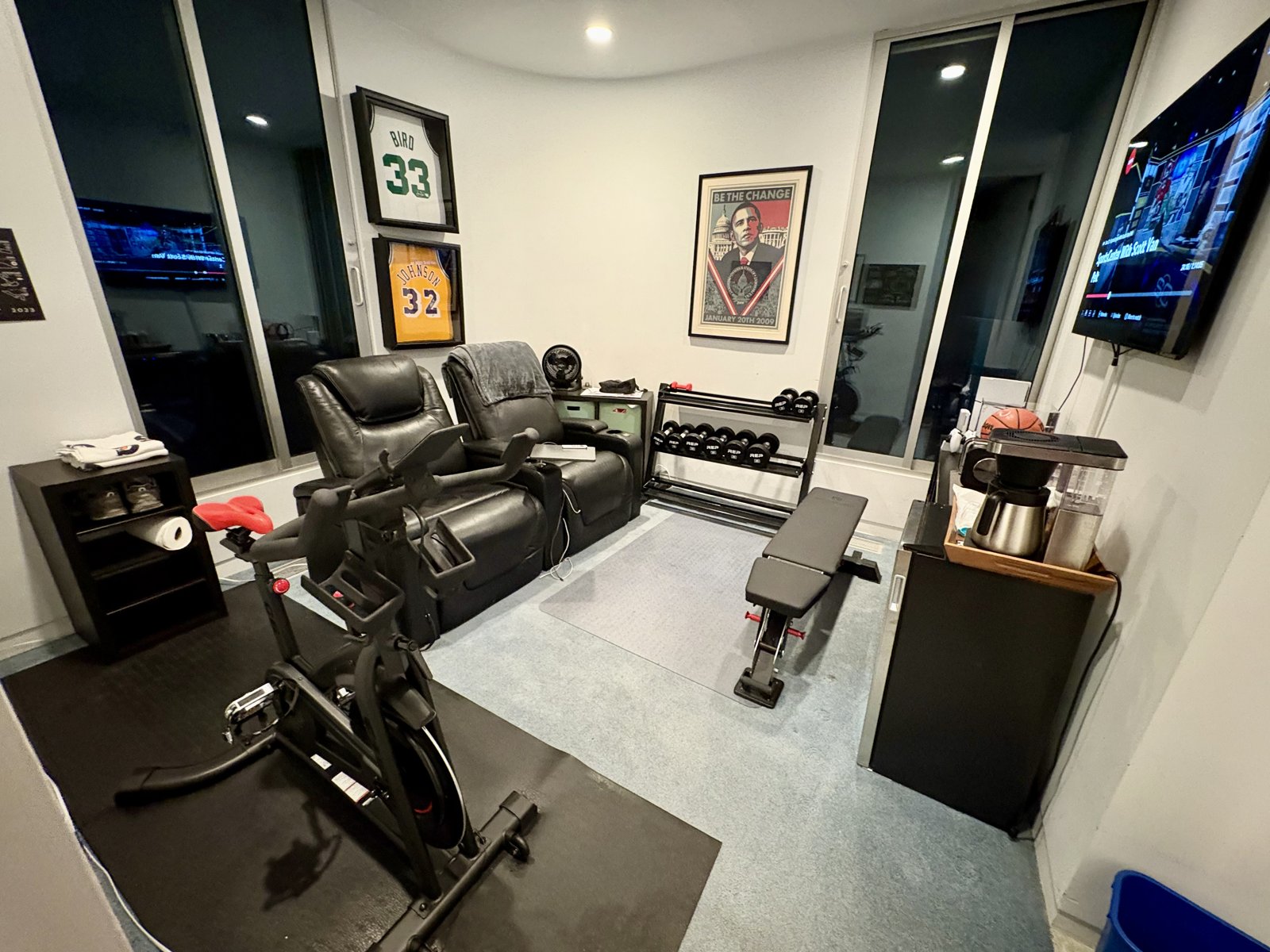 My home office set up for lifting: an adjustable bench and dumbbells in the corner
