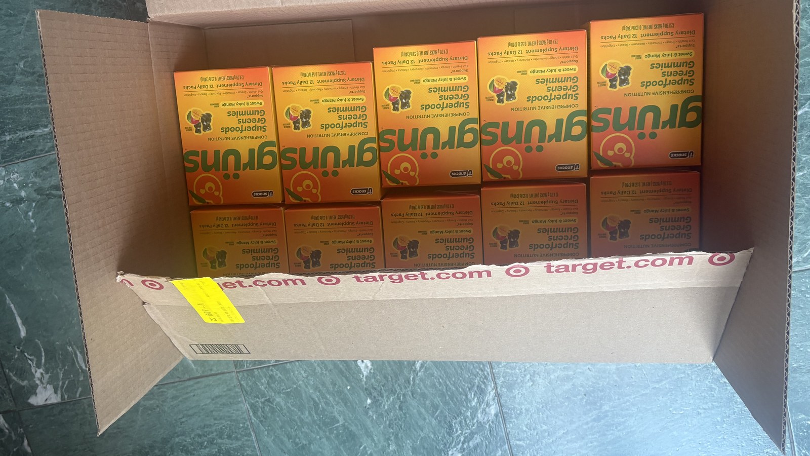 An opened Target.com shipping box packed with boxes of gruns Superfoods Greens Gummies