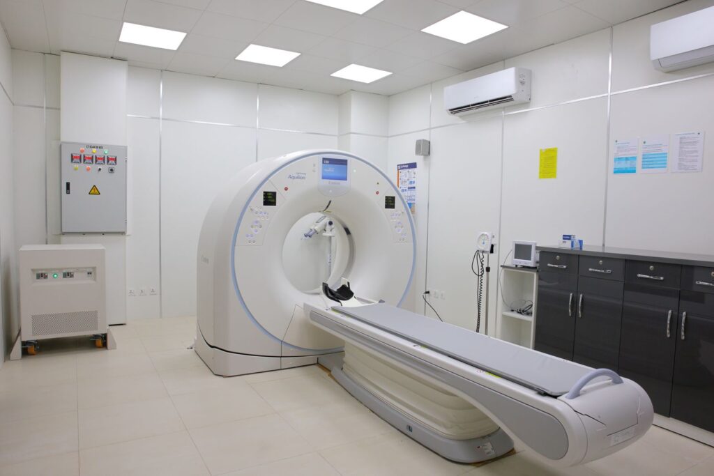 A modern CT scanner in a bright hospital imaging room