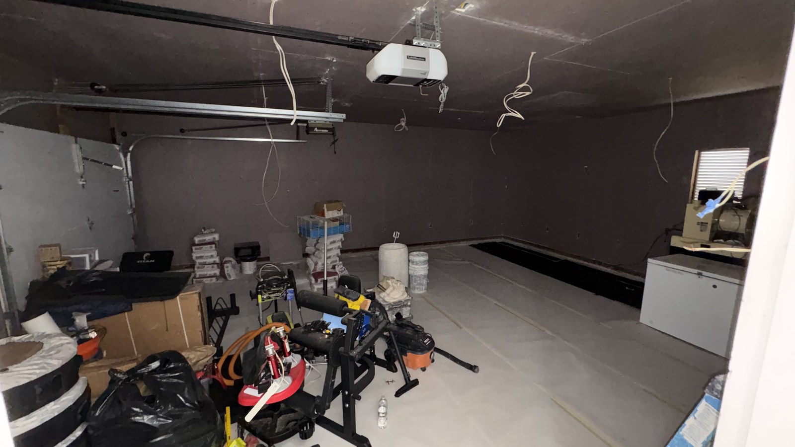 The garage mid-build with drywall up and the ceiling finished, before the floor and the equipment went in.